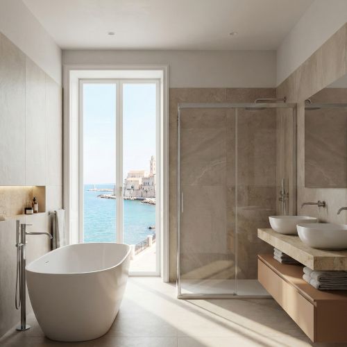 Un bagno moderno e raffinato, con una vasca da bagno freestanding, un'ampia doccia e un doppio lavabo. L'elemento distintivo &egrave; la grande finestra che offre una vista mozzafiato sul mare e sul centro storico di Bari, creando un'atmosfera da catalogo di alta gamma.